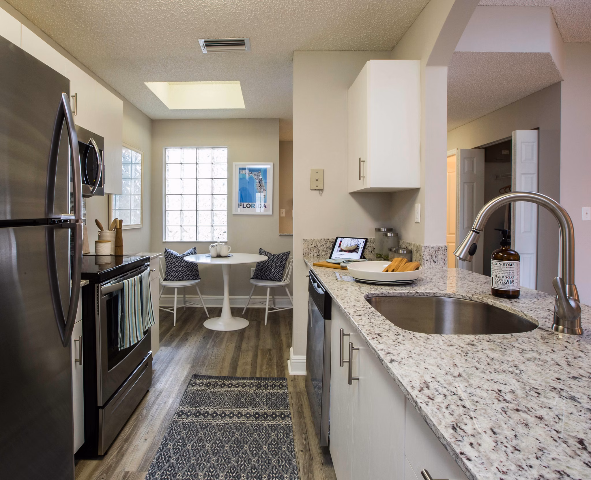 Modern kitchen with granite countertops and stainless steel appliances at Citation Club luxury apartments