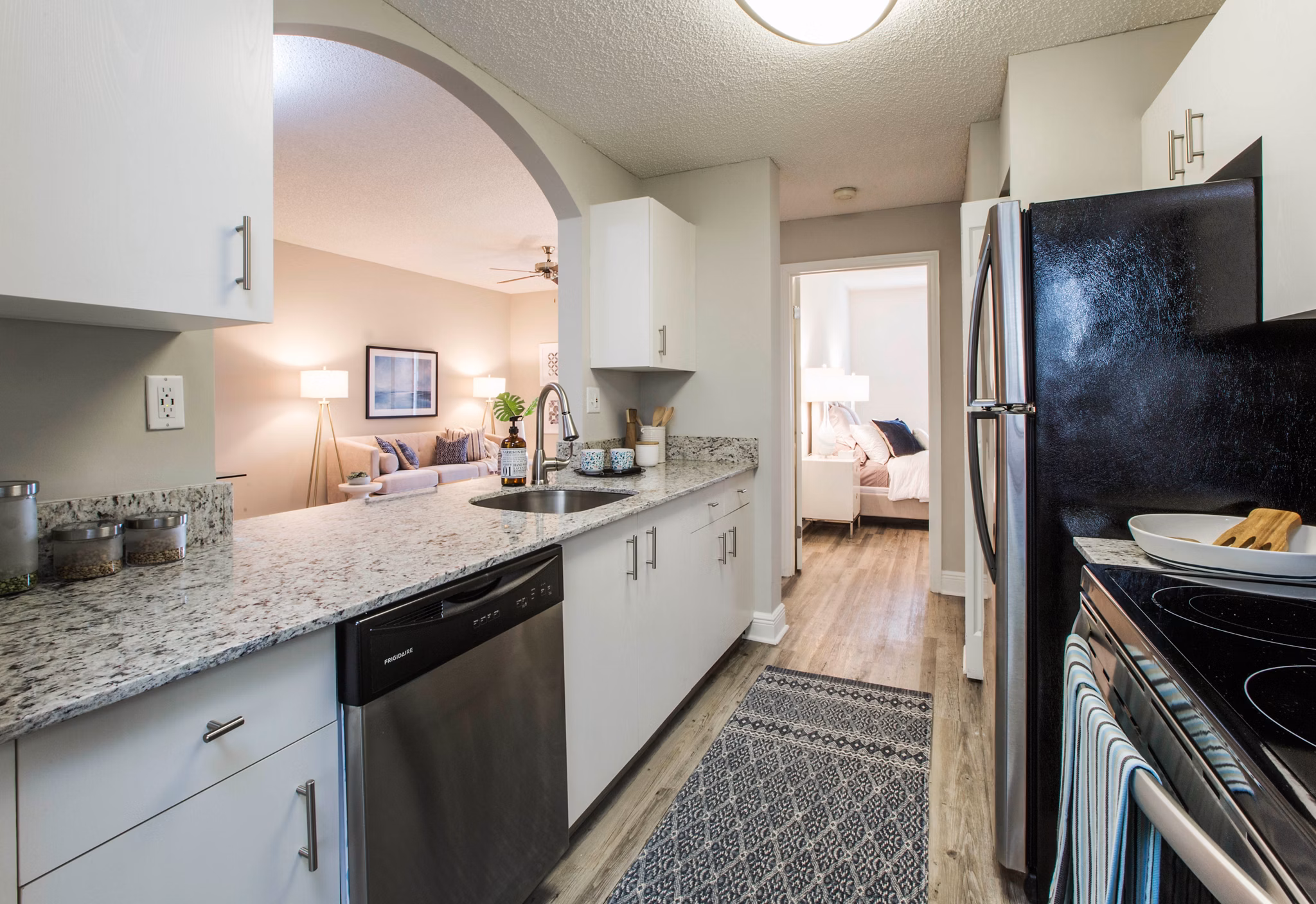 Modern kitchen with granite countertops and stainless steel appliances in Citation Club Apartments