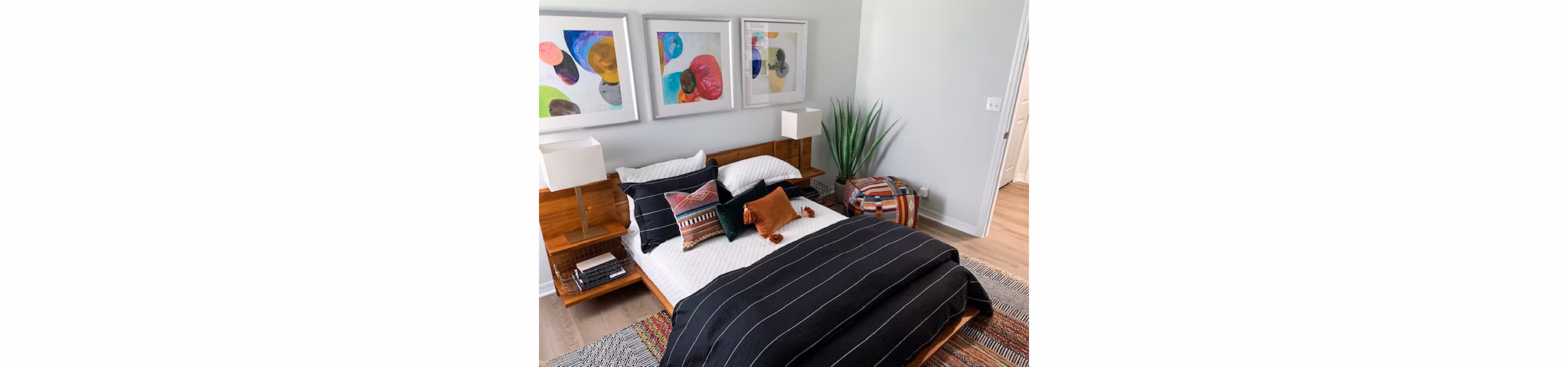 Cozy bedroom with modern furniture at Parks at Hunter's Creek Apartments, offering luxury living in a tranquil setting
