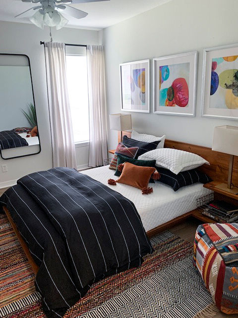 Cozy bedroom with modern decor at Parks at Hunter's Creek Apartments, offering luxury living in a serene setting