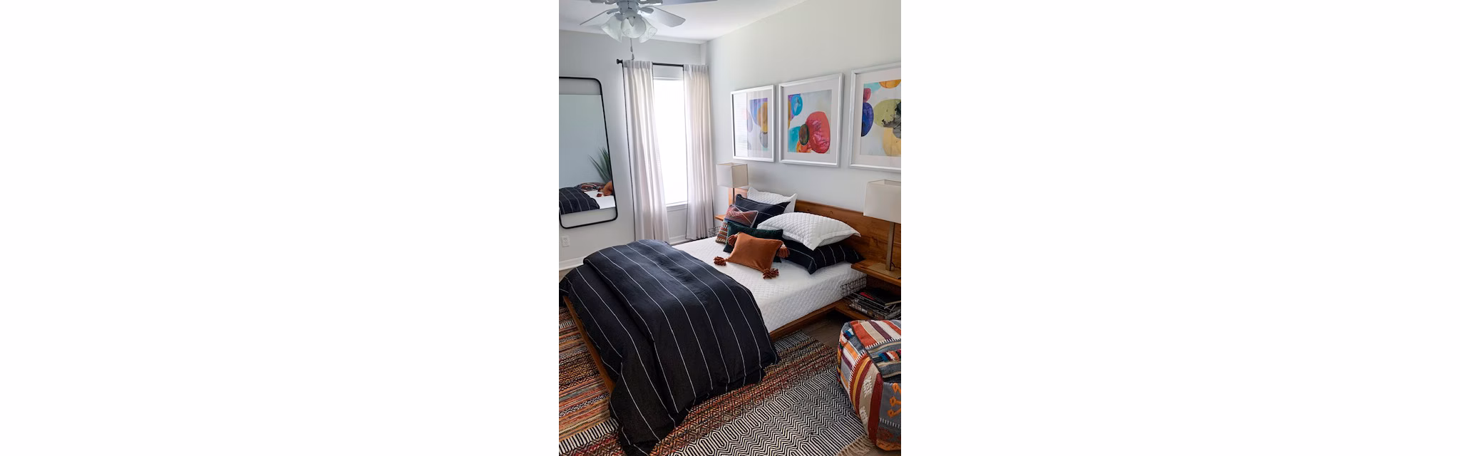Cozy bedroom with modern decor at Parks at Hunter's Creek Apartments, offering luxury living in a serene setting