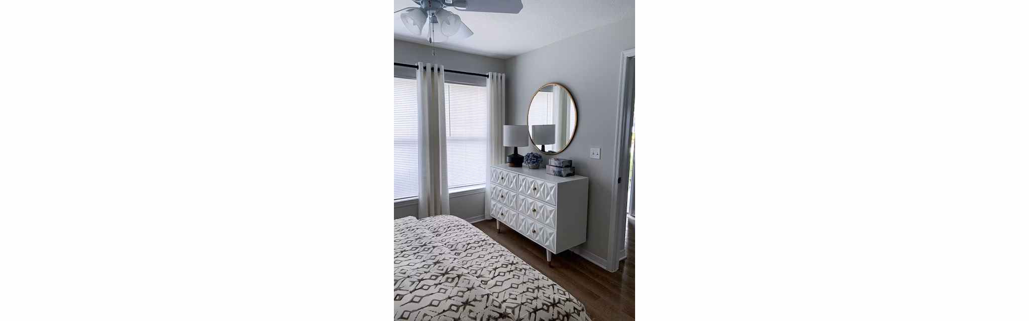 Bedroom with plush bedding and modern accents at Parks at Hunter's Creek Apartments