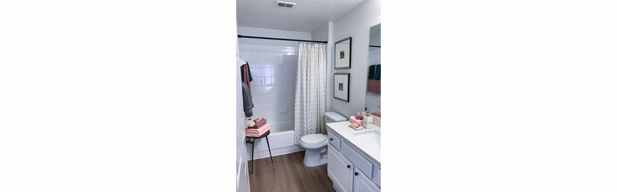 Modern bathroom with sleek fixtures and large mirror at Parks at Hunter's Creek Apartments