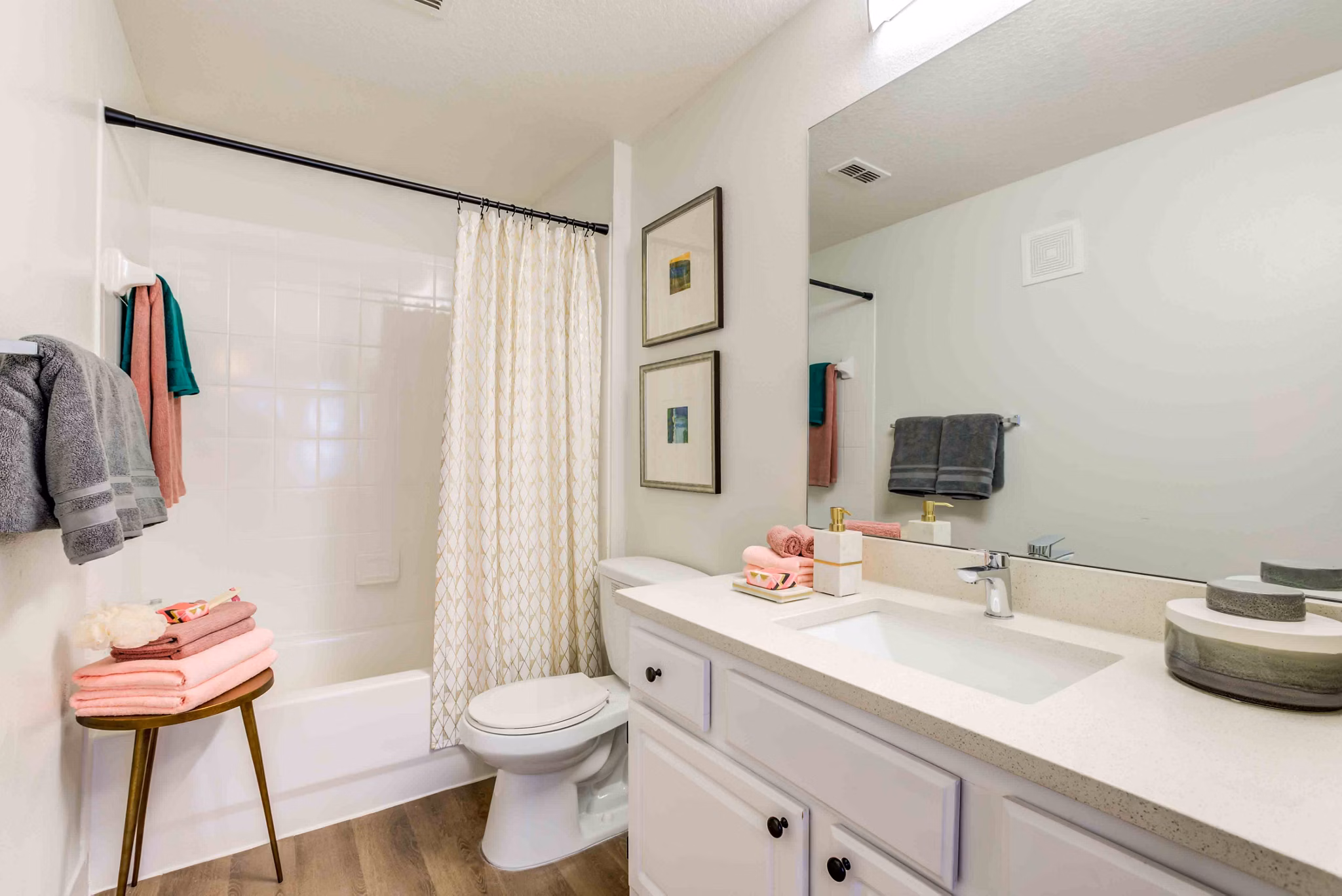 Bathroom featuring modern fixtures and large mirror at Parks at Hunter's Creek Apartments, offering luxury living in a desirable community