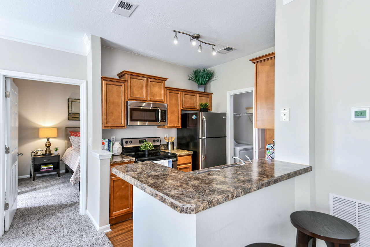Contemporary kitchen with stainless steel appliances at 54 Magnolia Apartments