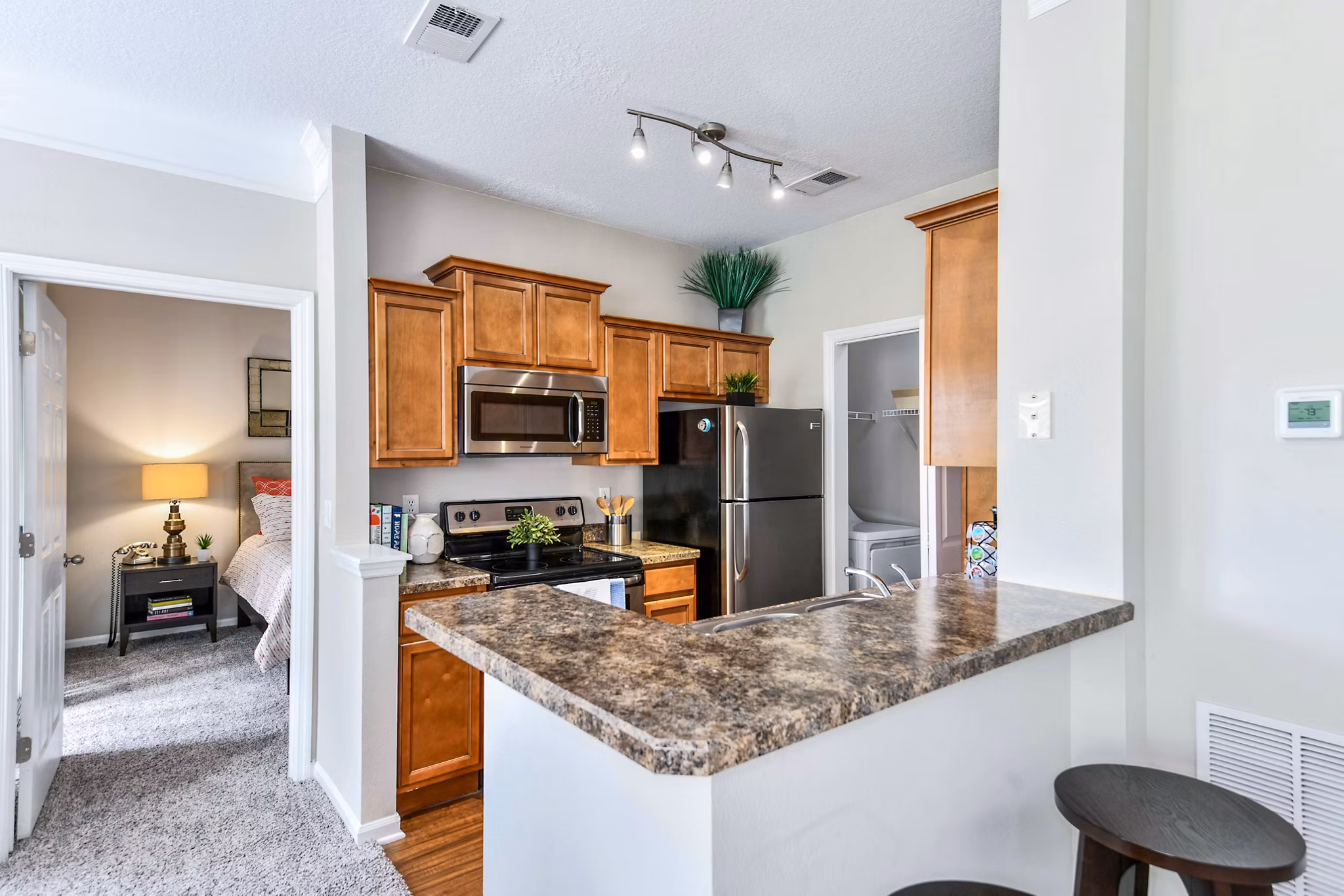 Contemporary kitchen with stainless steel appliances at 54 Magnolia Apartments
