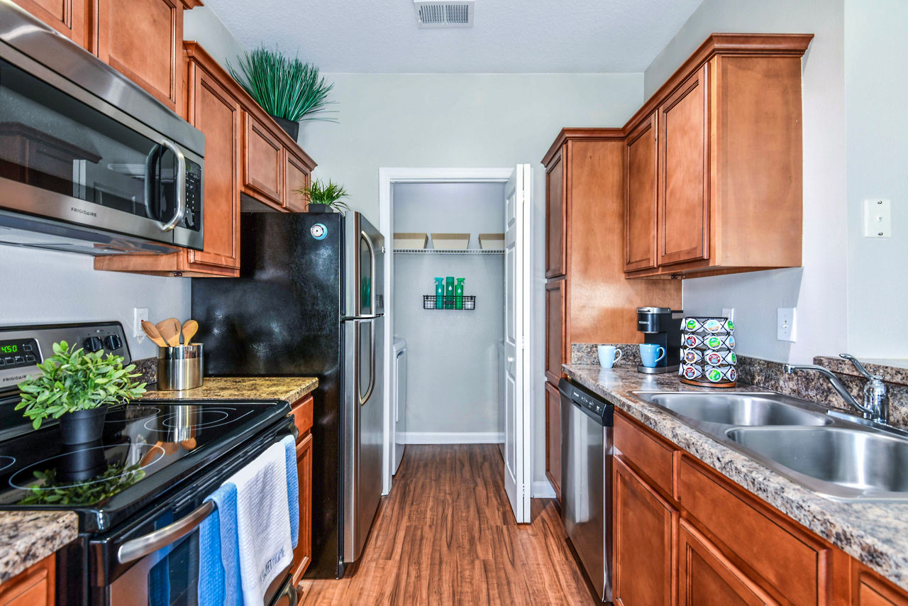 Modern kitchen with stainless steel appliances and granite countertops in 54 Magnolia Apartmentsâ€™ luxury unit