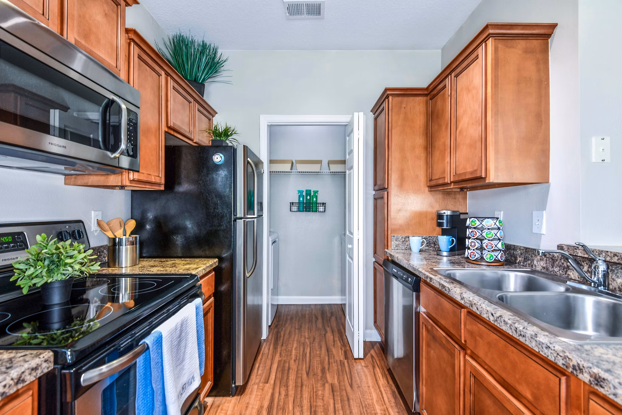 Modern kitchen with stainless steel appliances and granite countertops in 54 Magnolia Apartmentsâ€™ luxury unit
