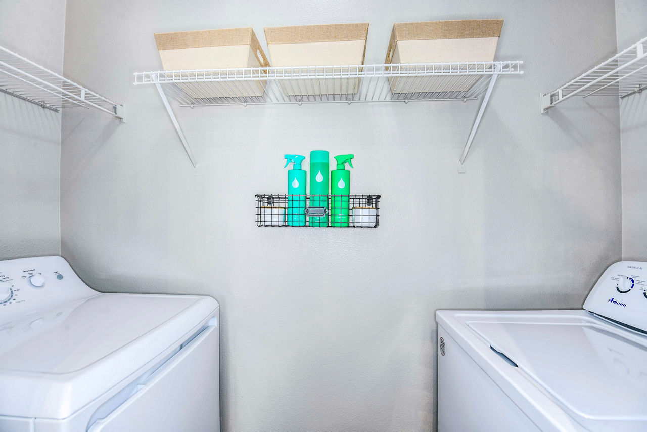 Laundry room featuring high-efficiency washers and dryers at 54 Magnolia Apartments - a luxury community by Greystar