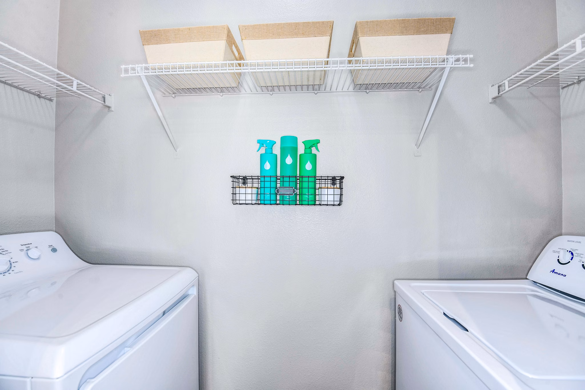 Laundry room featuring high-efficiency washers and dryers at 54 Magnolia Apartments - a luxury community by Greystar