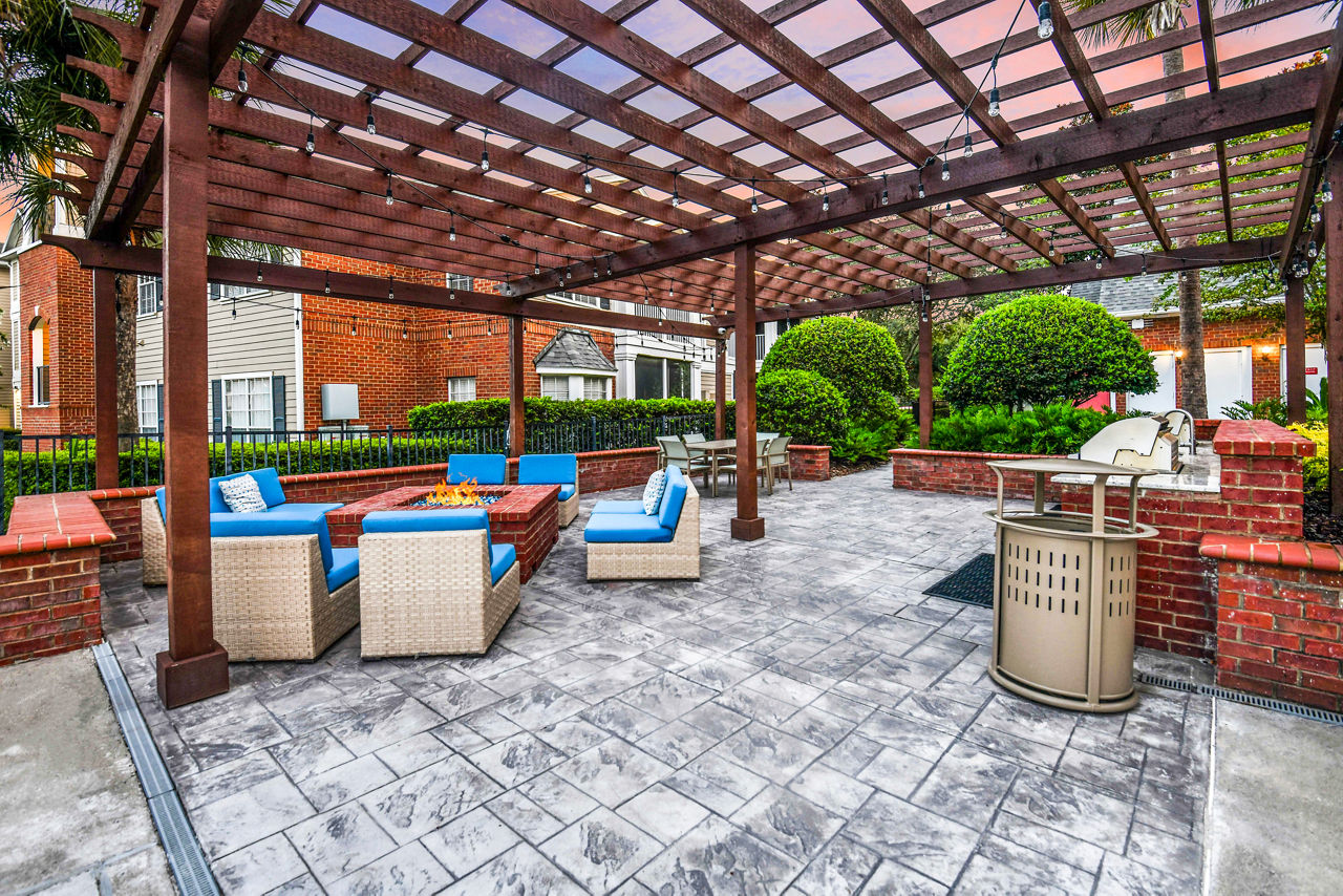 Outdoor seating area with modern fire pit on the patio at 54 Magnolia Apartments Perfect for relaxation and social gatherings in luxury surroundings