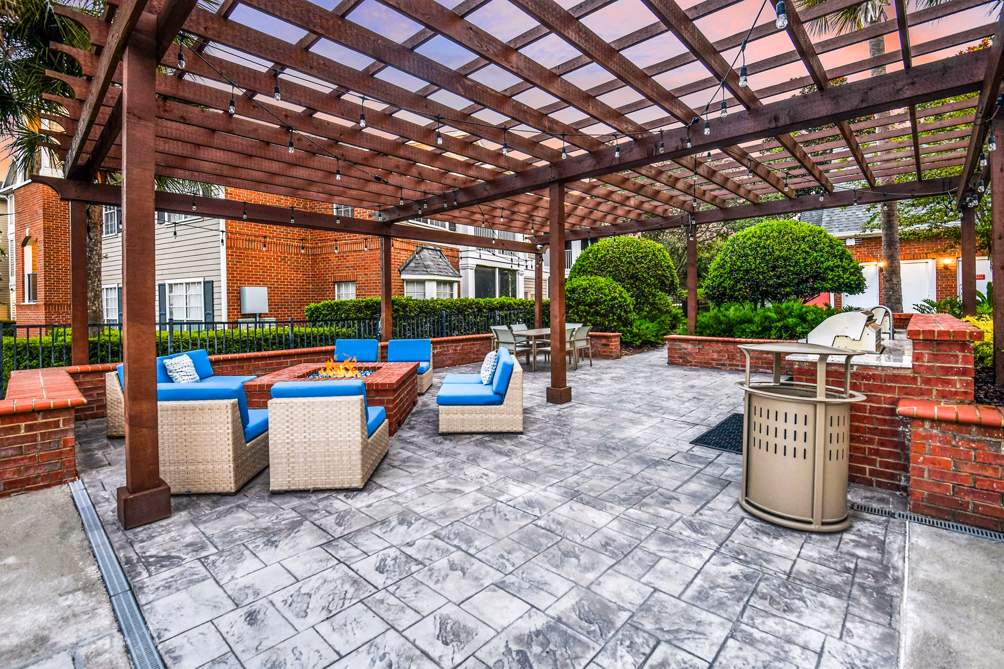 Outdoor seating area with modern fire pit on the patio at 54 Magnolia Apartments Perfect for relaxation and social gatherings in luxury surroundings
