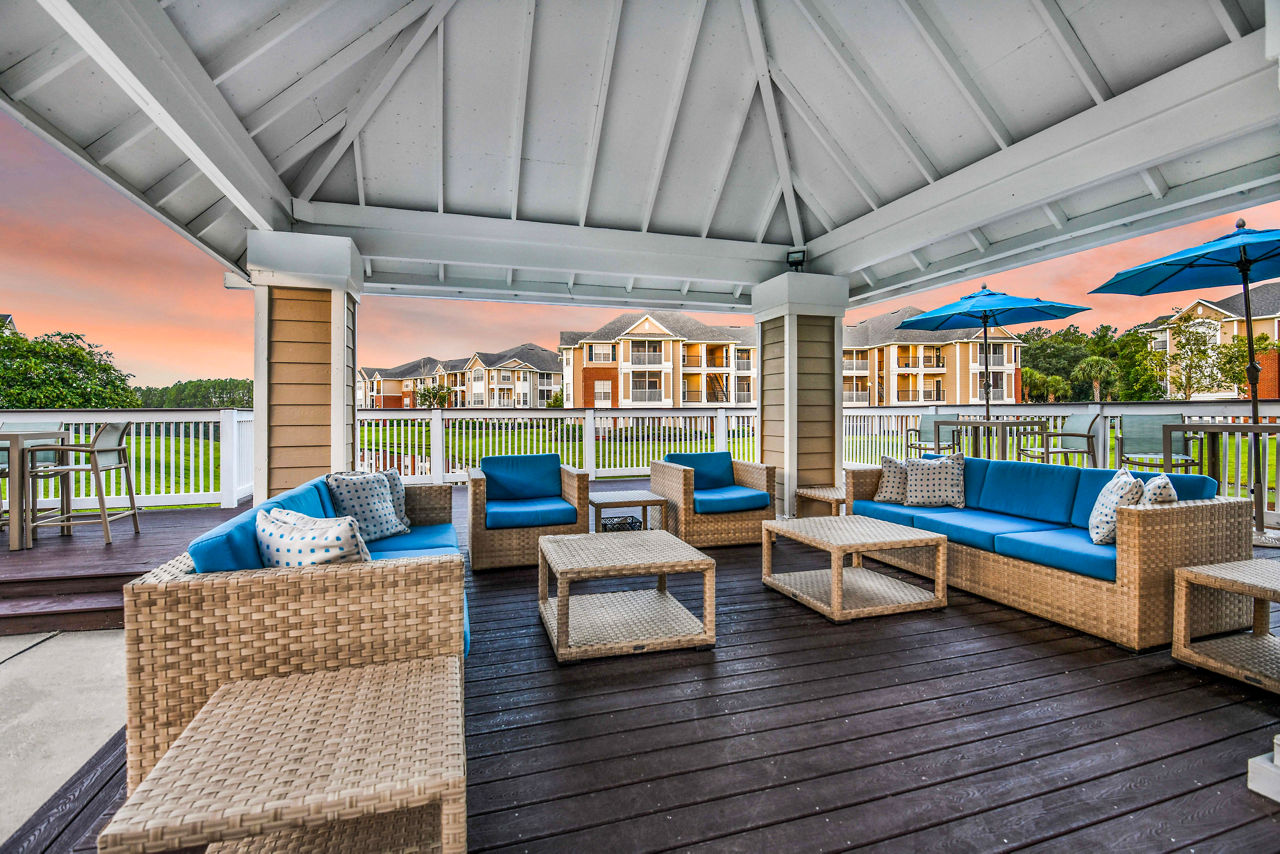Charming outdoor patio with seating and greenery at 54 Magnolia Apartments, a luxury Greystar property