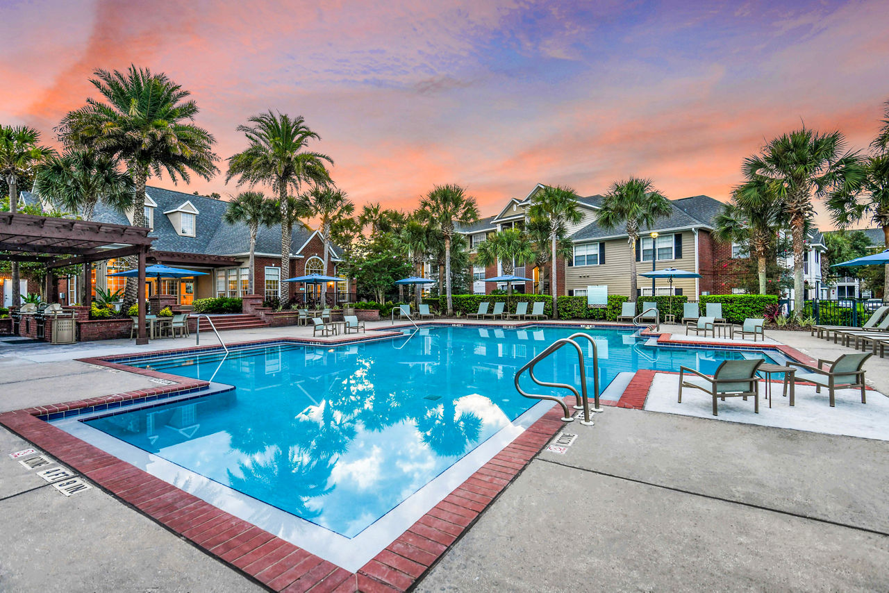 Pool area with stylish loungers at 54 Magnolia Apartments offering luxury relaxation amenities