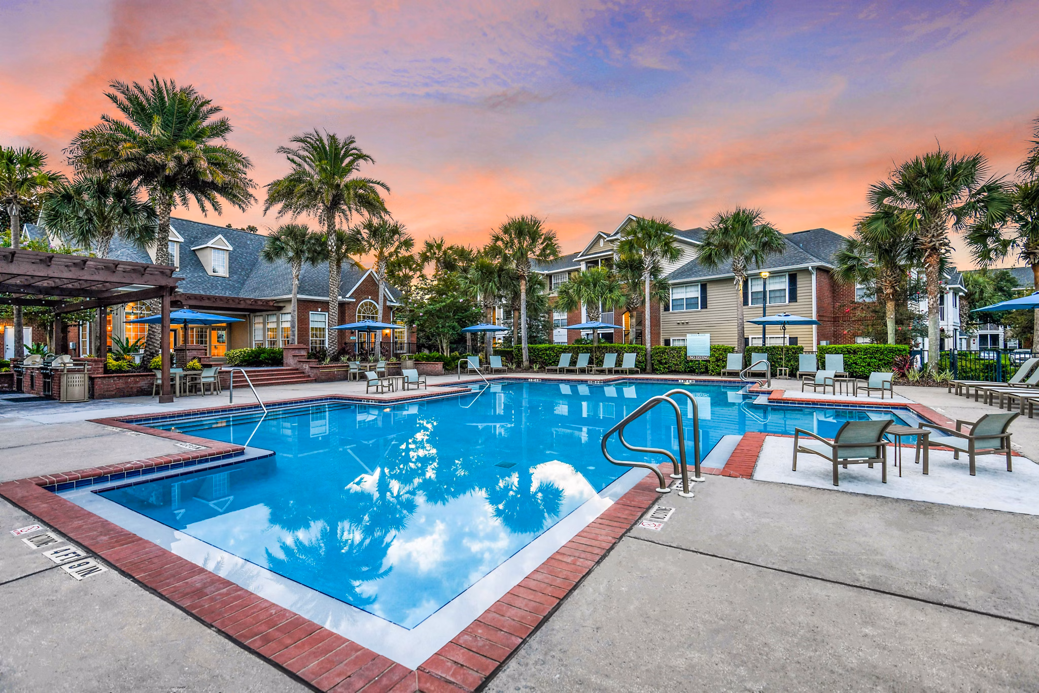 Pool area with stylish loungers at 54 Magnolia Apartments offering luxury relaxation amenities