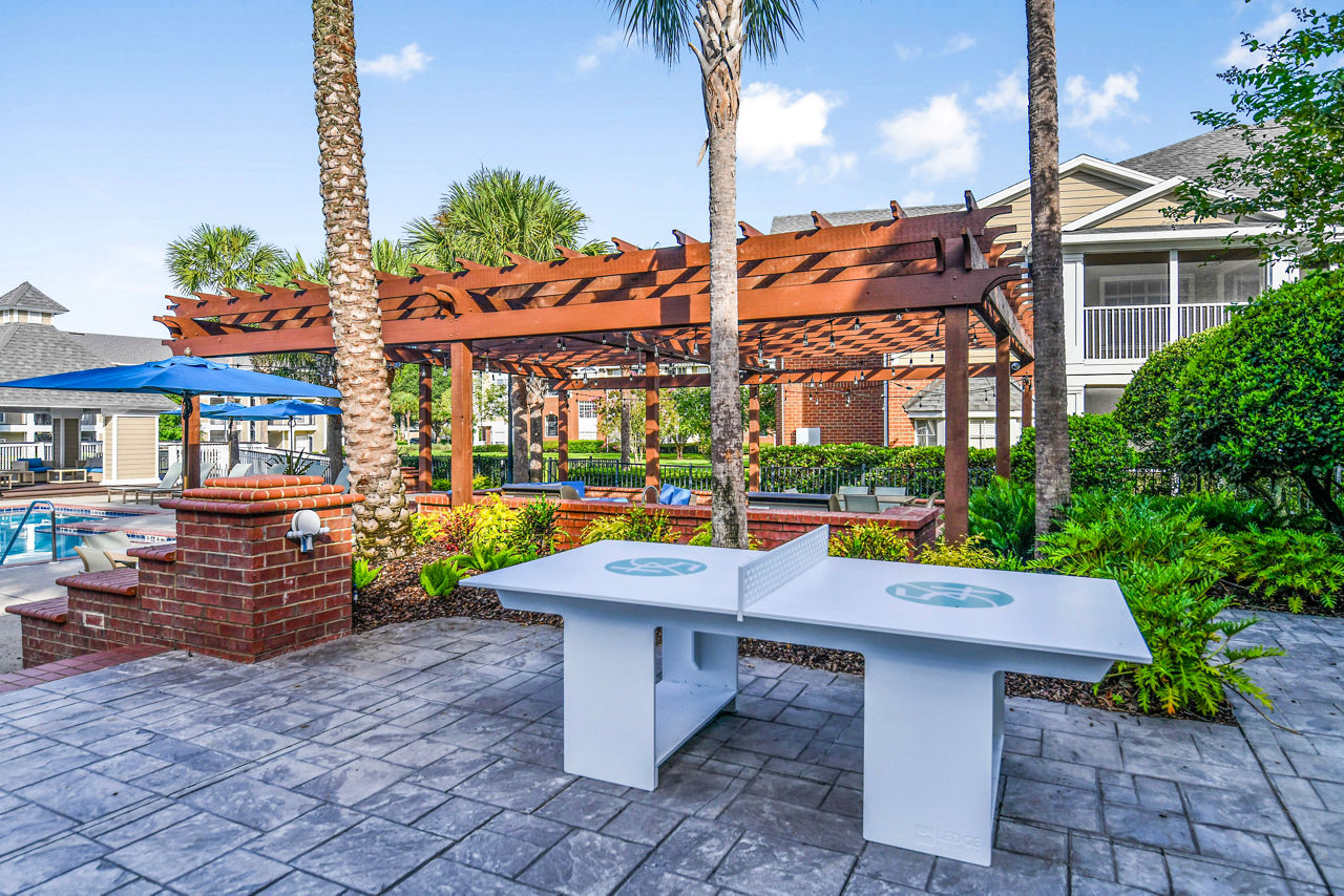 Recreational table tennis area at 54 Magnolia Apartments with modern decor and cozy seating