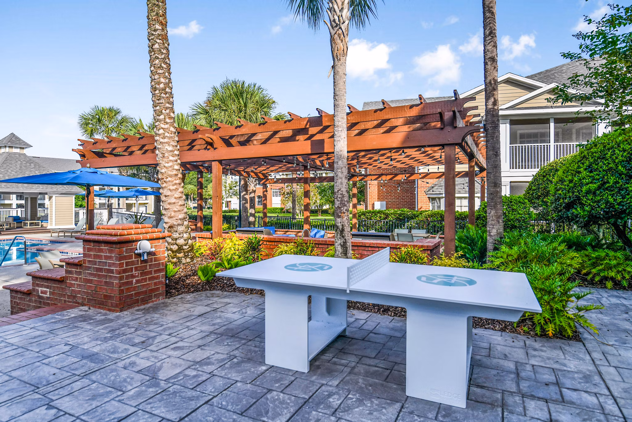 Recreational table tennis area at 54 Magnolia Apartments with modern decor and cozy seating