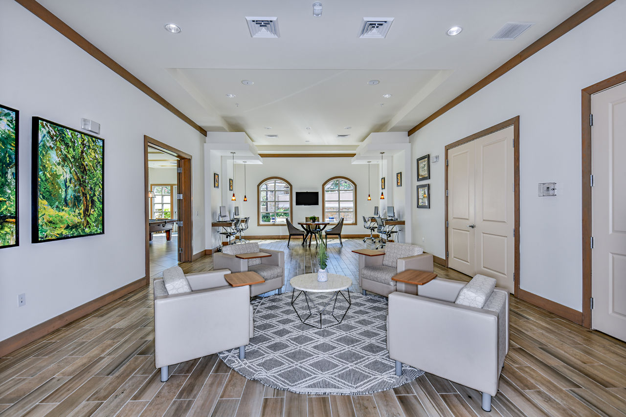 Clubhouse with modern design and seating areas at Sanctuary at Eagle Creek Apartments