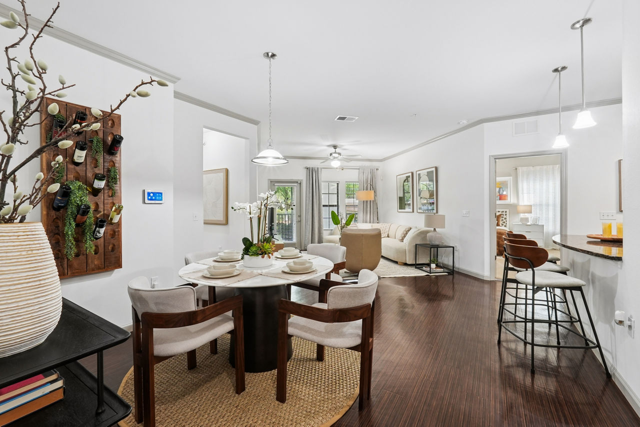 Spacious living room with modern decor in Sanctuary at Eagle Creek Apartments, featuring plush seating and ample natural light