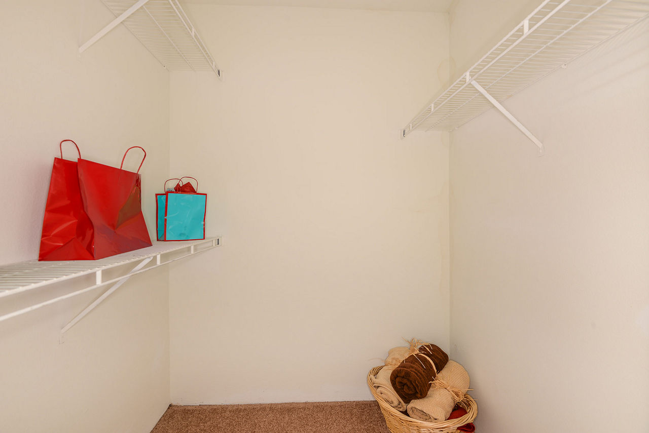 Walk-in closet with ample storage space in Stonebrook Apartments