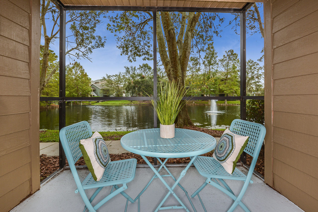 Tranquil outdoor patio with lush greenery at Stonebrook Apartments, perfect for relaxation and social gatherings