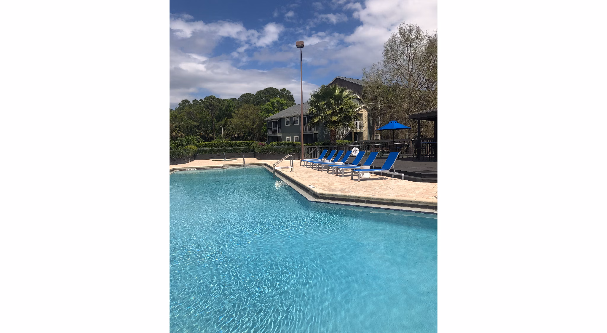 Luxurious pool with sun loungers at Stonebrook Apartments offering relaxation and recreation