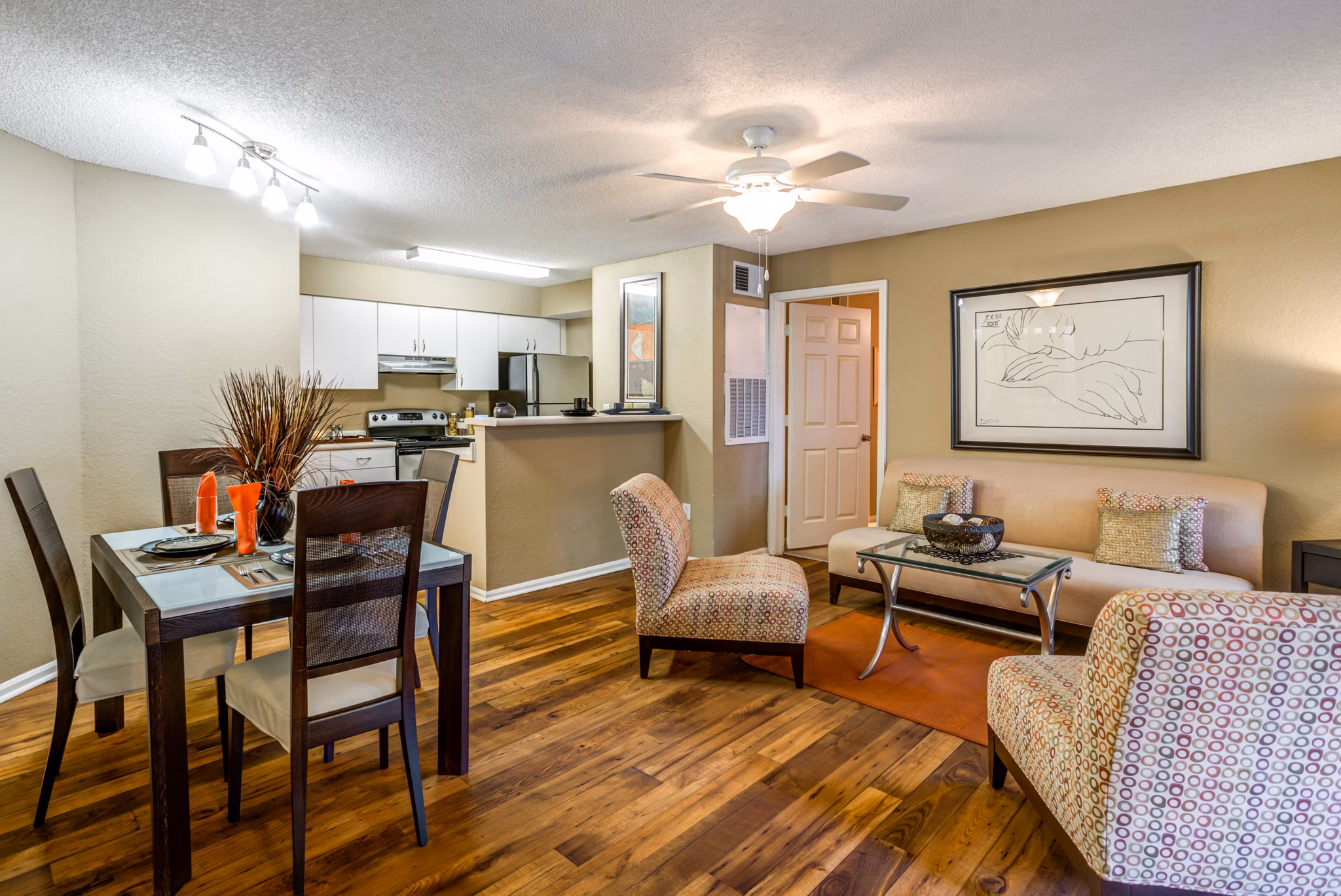 Modern living room with plush furnishings and large windows in Park Central Apartments - Manor Row