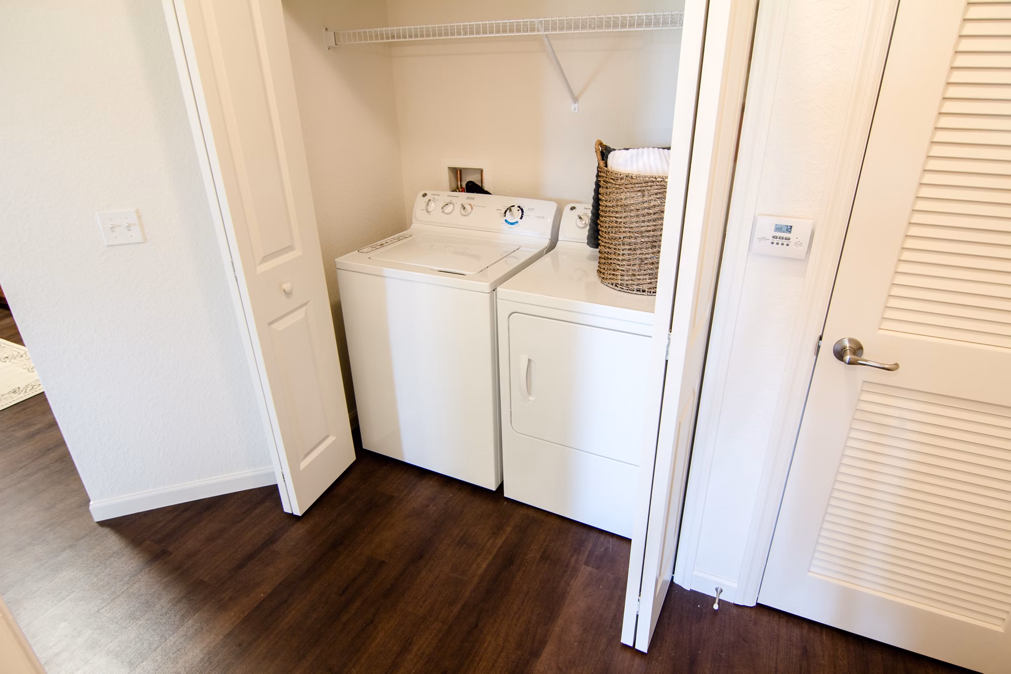 Laundry room with modern washers and dryers at The Vineyards at Hammock Ridge Apartments in quiet suburban setting