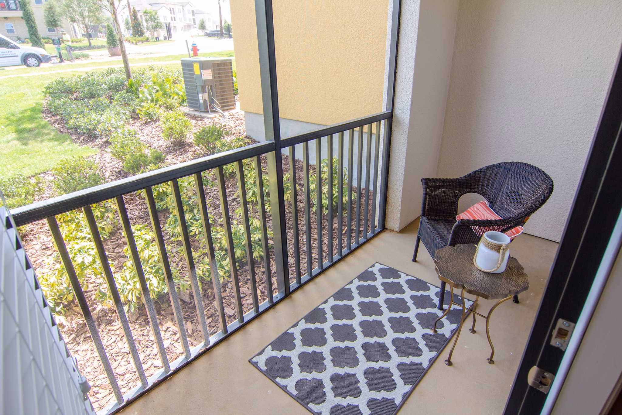 Modern patio with cozy seating area at The Vineyards at Hammock Ridge Apartments