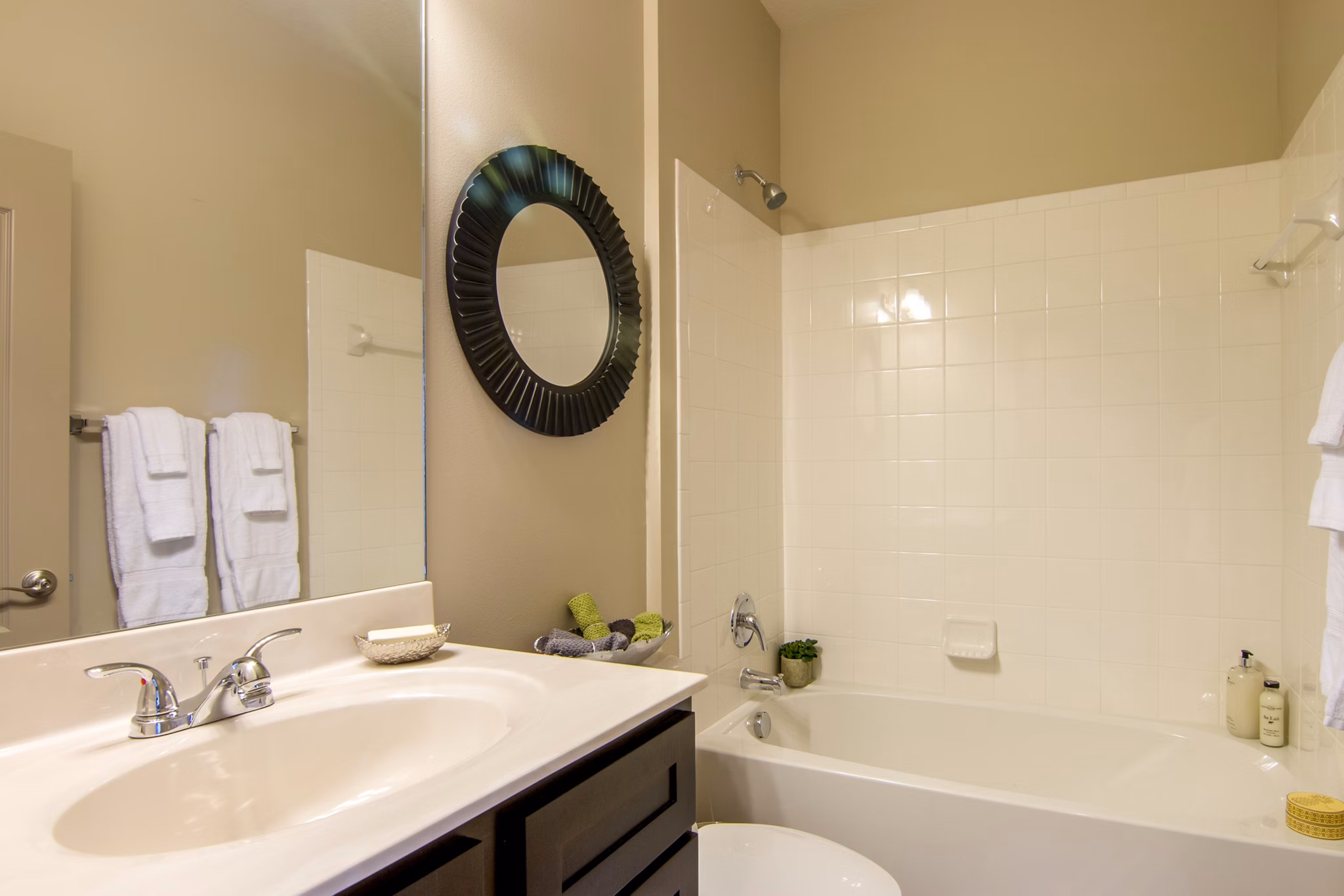 Modern bathroom with sleek fixtures and ample lighting at Midtown Delray Apartments