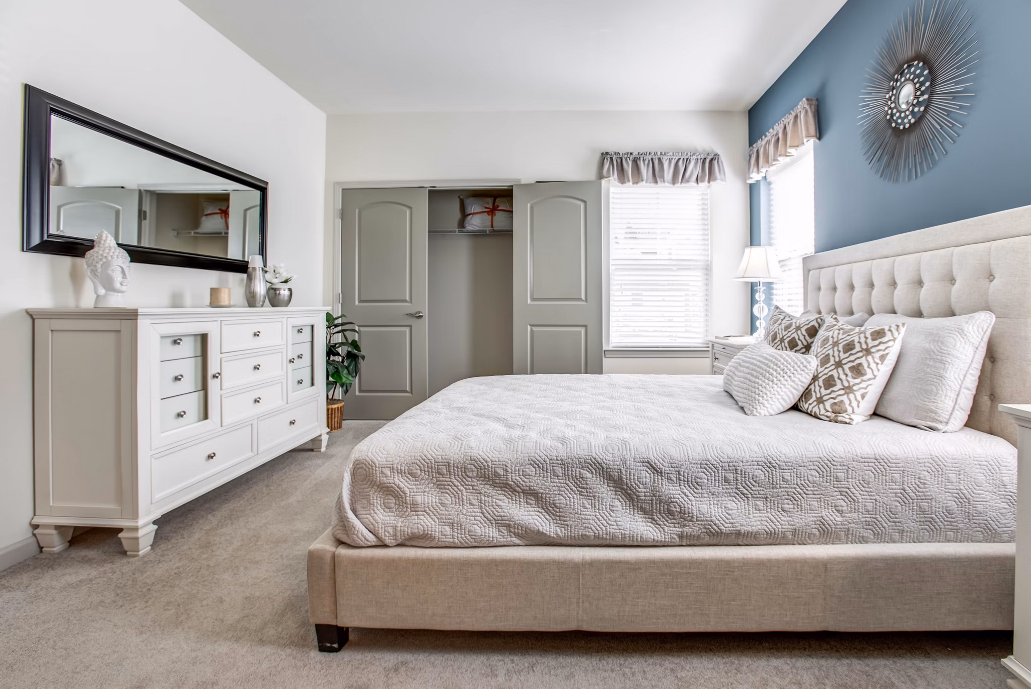 Cozy bedroom with modern decor in The Reserve at the Boulevard Apartments