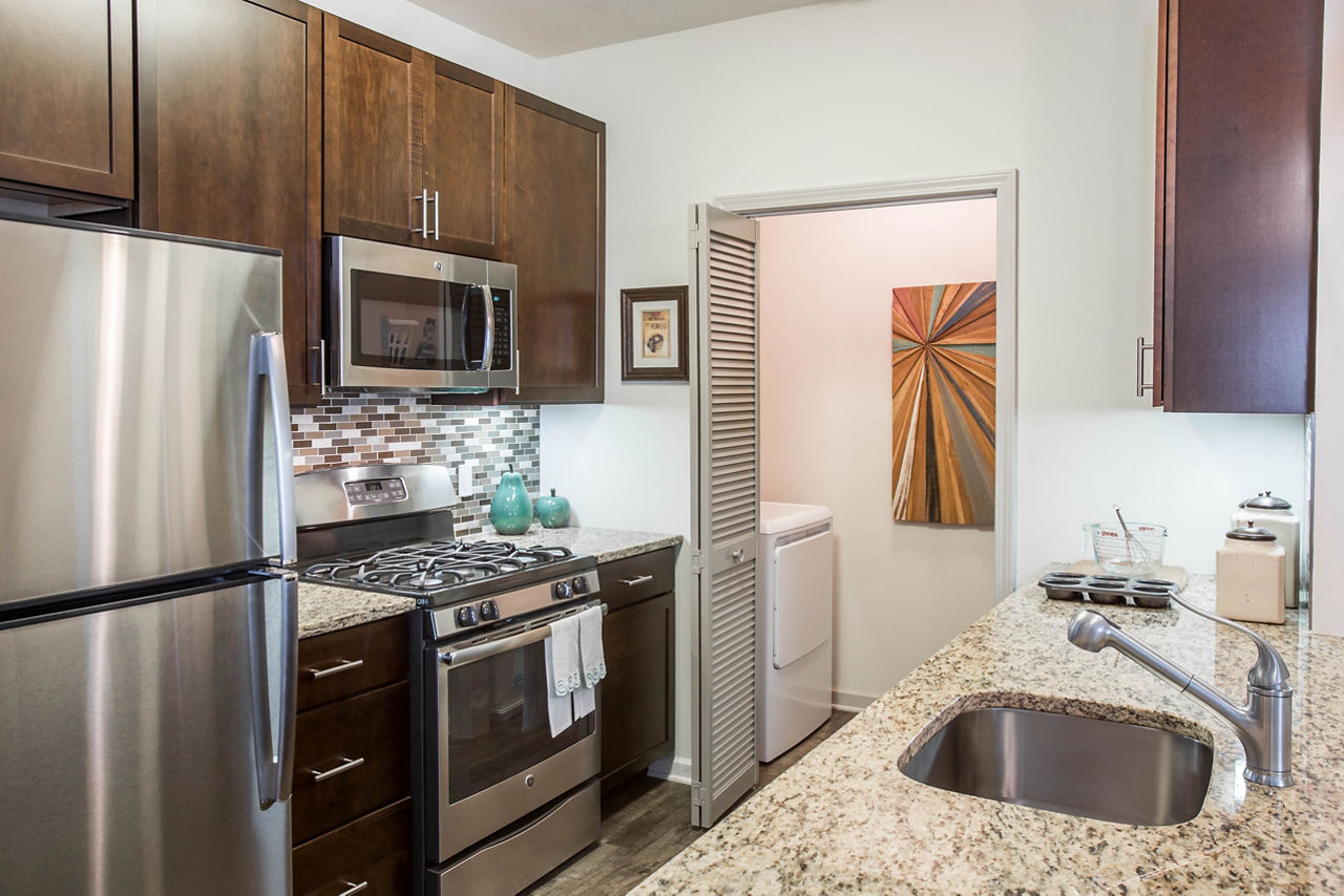Modern kitchen with stainless steel appliances at The Reserve at the Boulevard Apartments