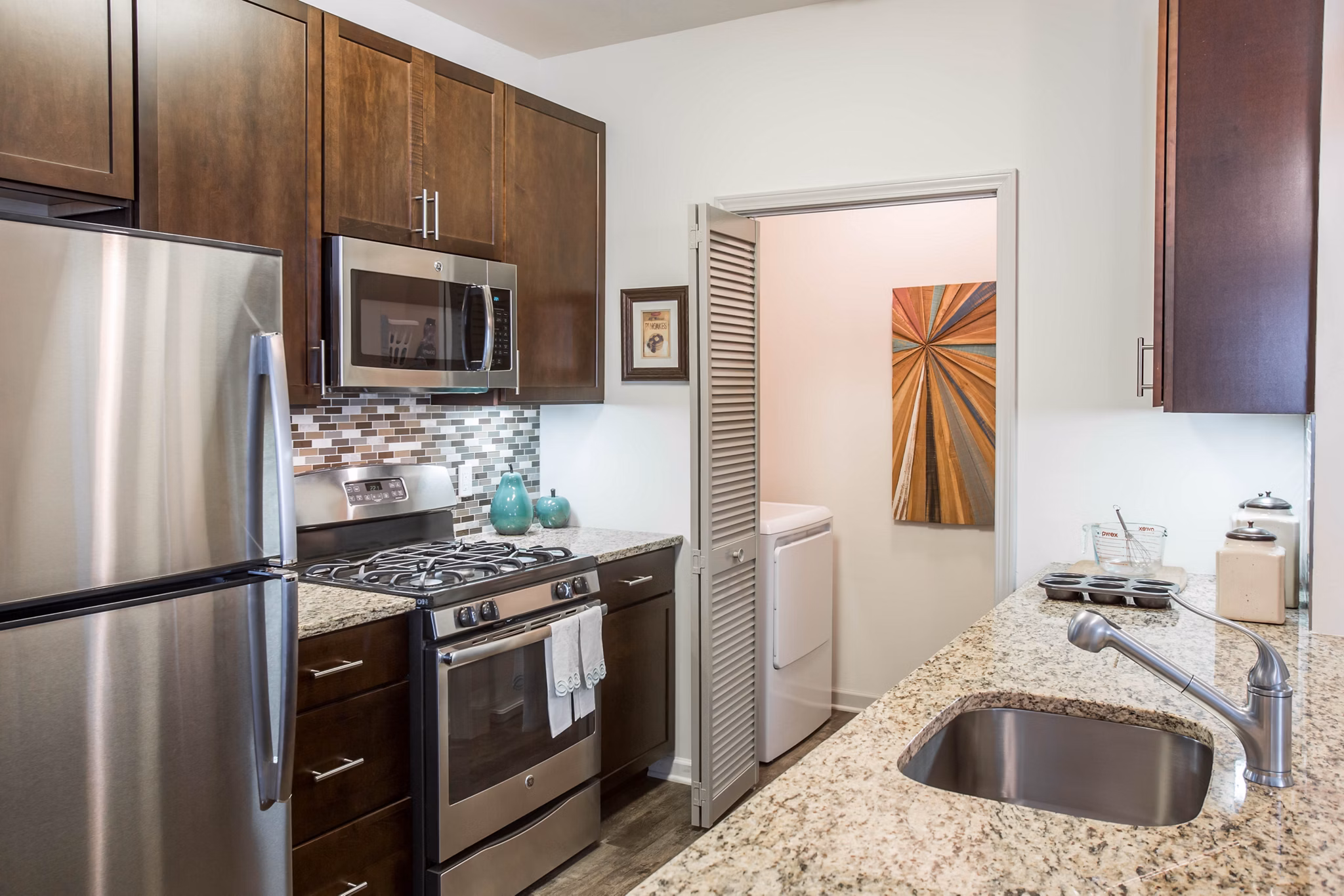 Modern kitchen with stainless steel appliances at The Reserve at the Boulevard Apartments