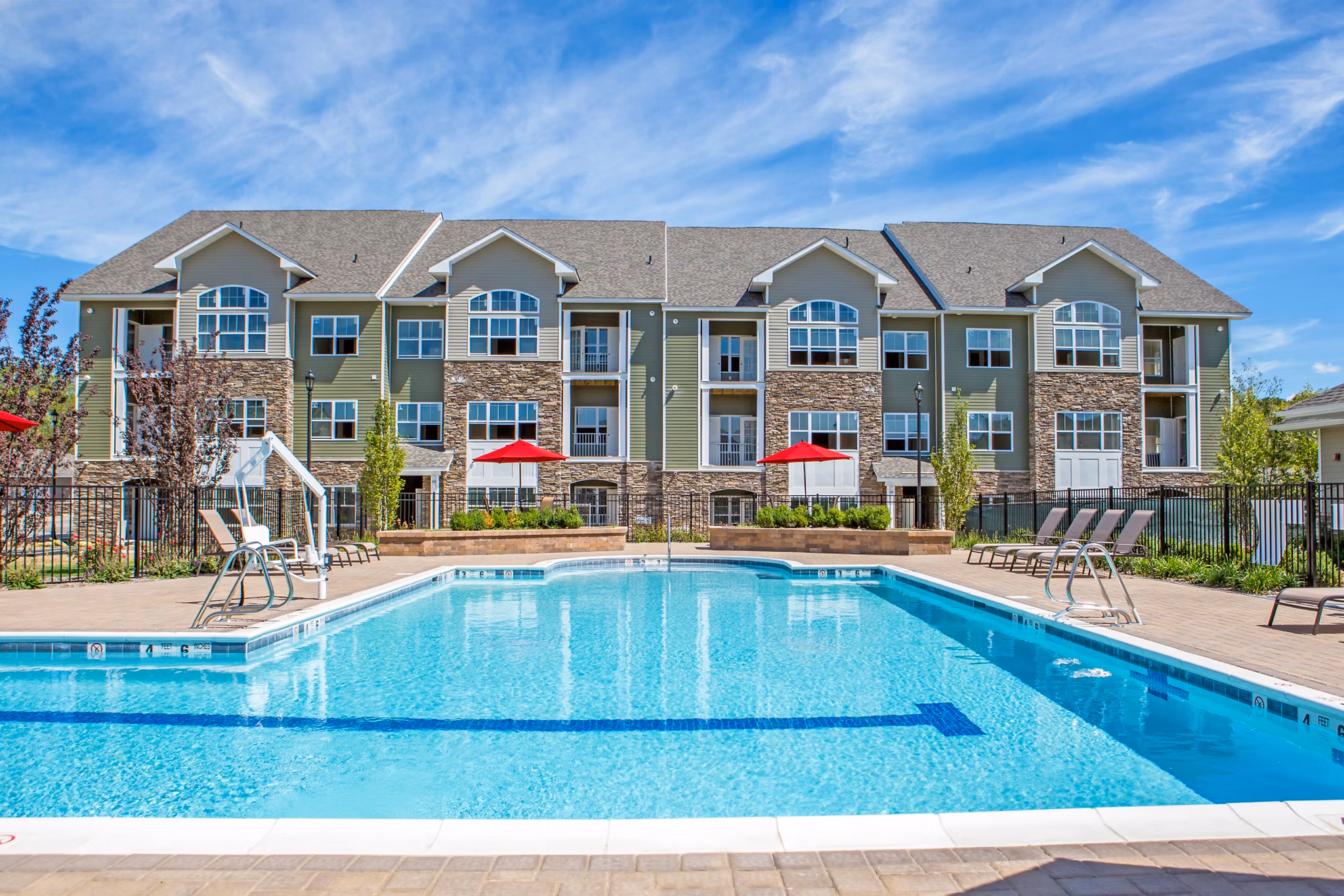 Resort-style pool with lounge chairs at The Reserve at the Boulevard Apartments