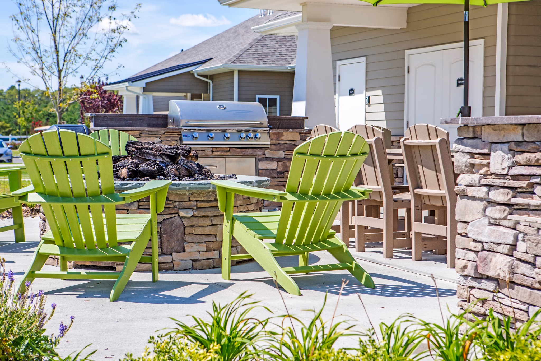 Outdoor grill area with seating at The Reserve at the Boulevard Apartments, a luxury living community
