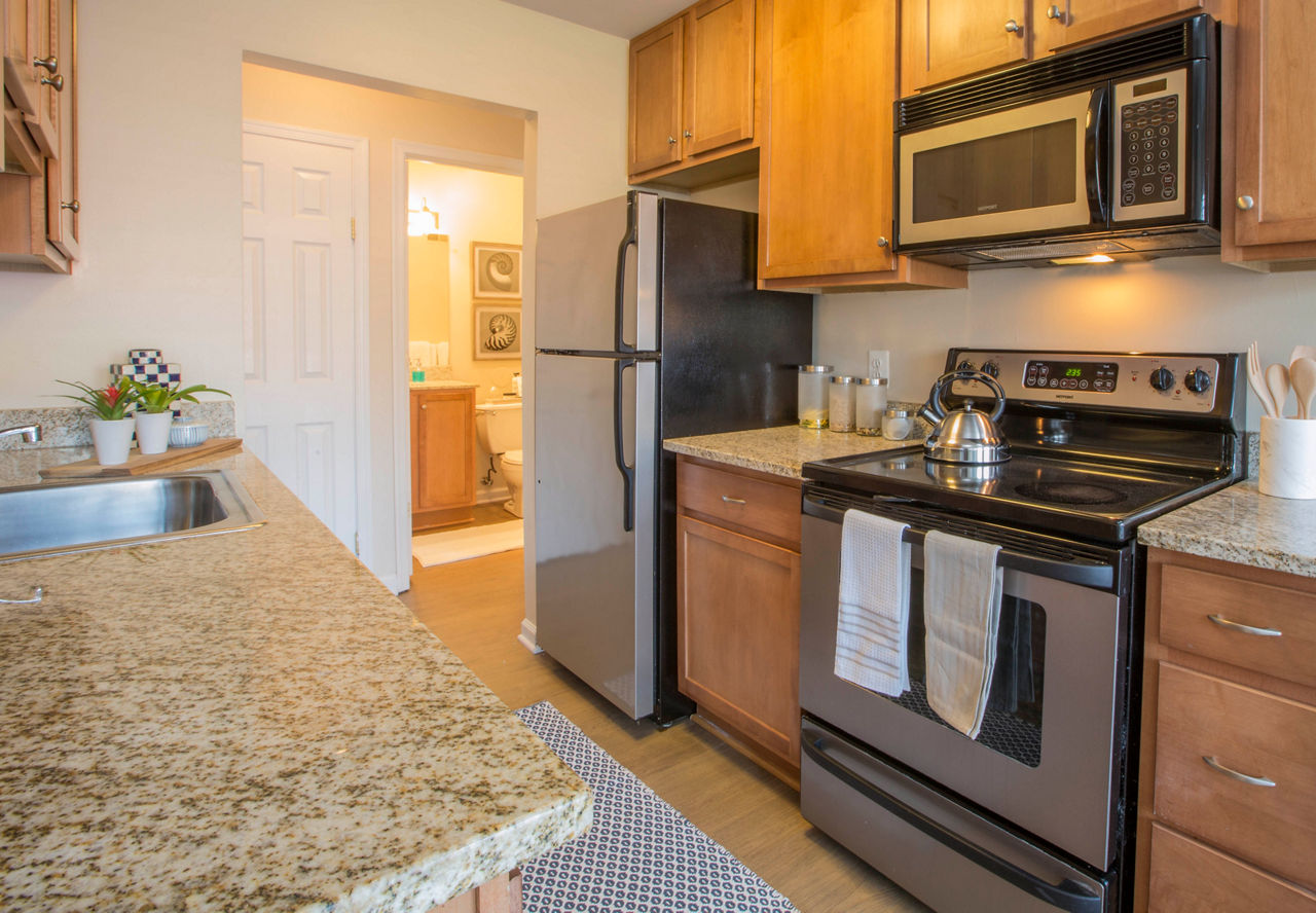 Modern kitchen with stainless steel appliances in Bayshore Landing Apartments