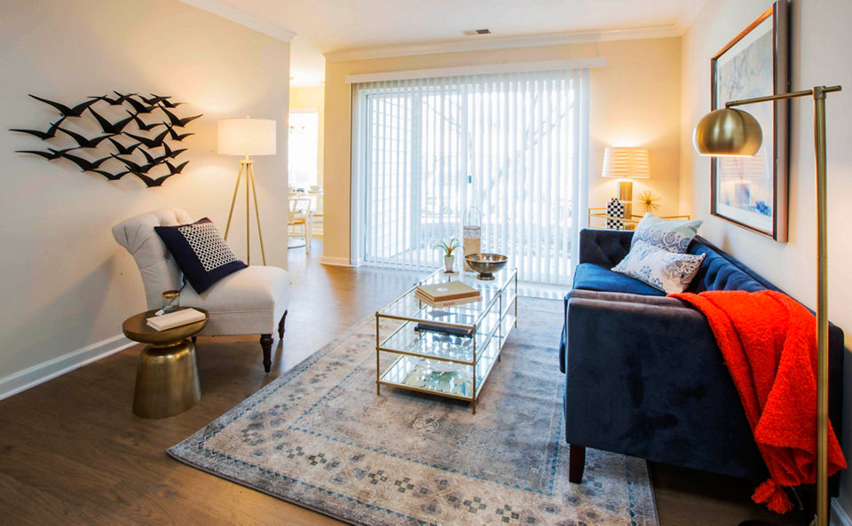 Spacious living room with modern decor and large windows at Bayshore Landing Apartments