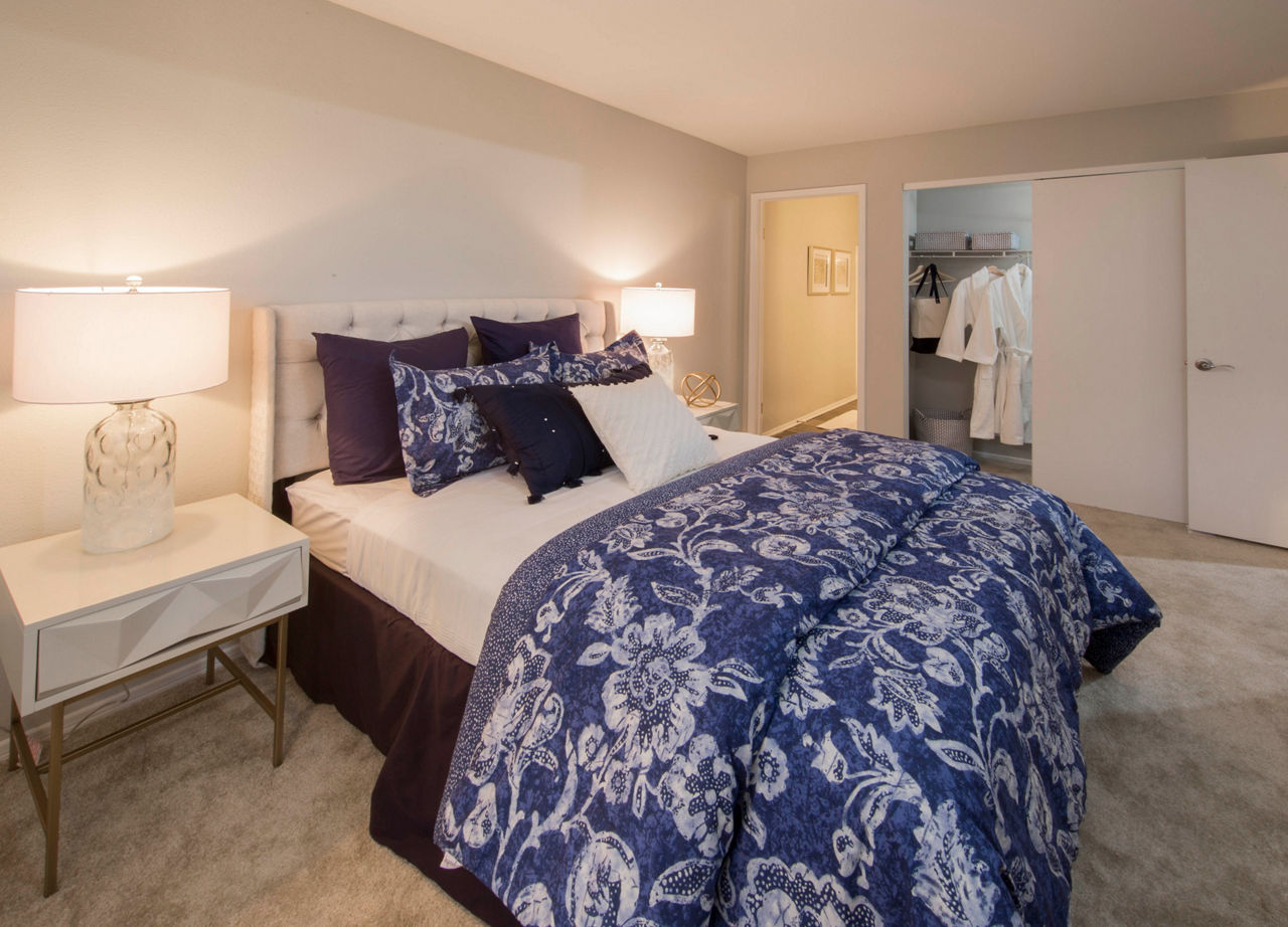 Cozy bedroom featuring elegant decor and natural light at Southfield Apartments, a luxury Greystar community