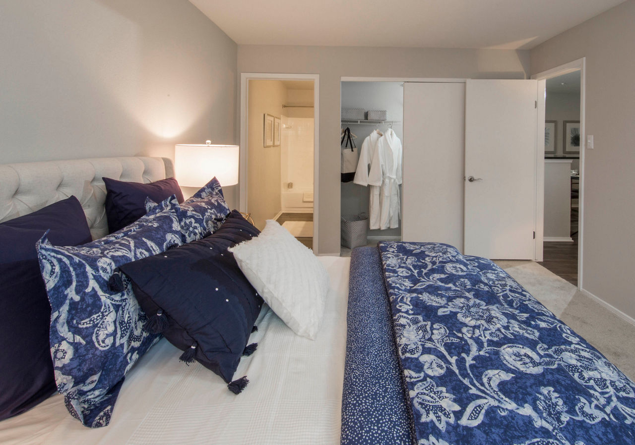 Cozy bedroom with modern furnishings in Southfield Apartments
