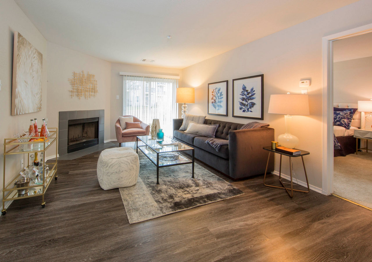 Modern living room with stylish decor and large windows at Southfield Apartments, a Greystar luxury property