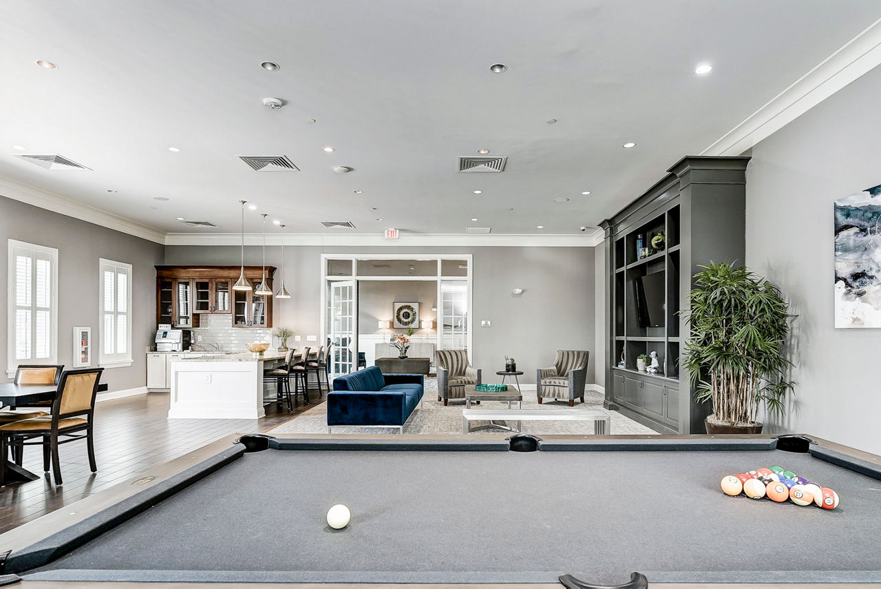Game room with pool table and arcade games at Paragon at Columbia Overlook Apartments, offering fun social activities for residents