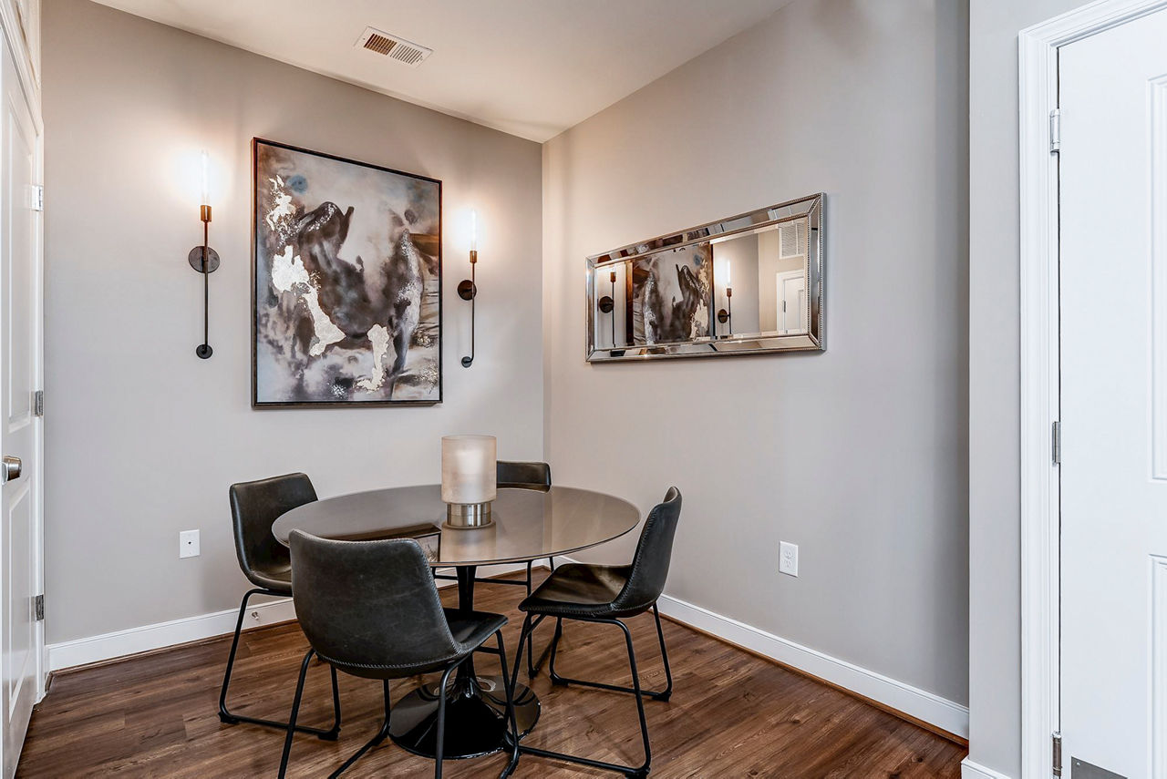Dining area featuring modern decor and hardwood flooring in Paragon at Columbia Overlook Apartments