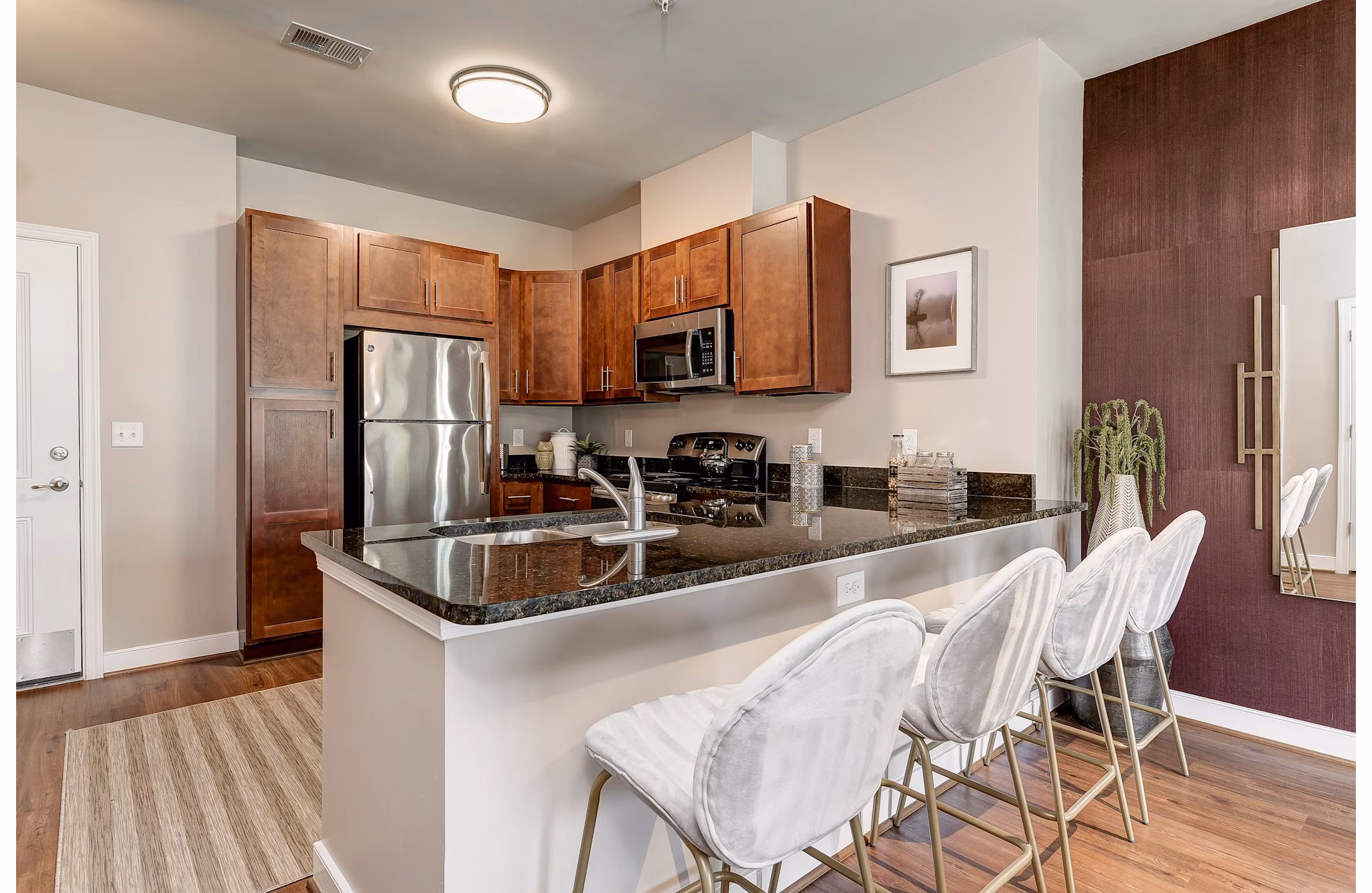 Modern kitchen featuring stainless steel appliances and granite countertops at Paragon at Columbia Overlook Apartments