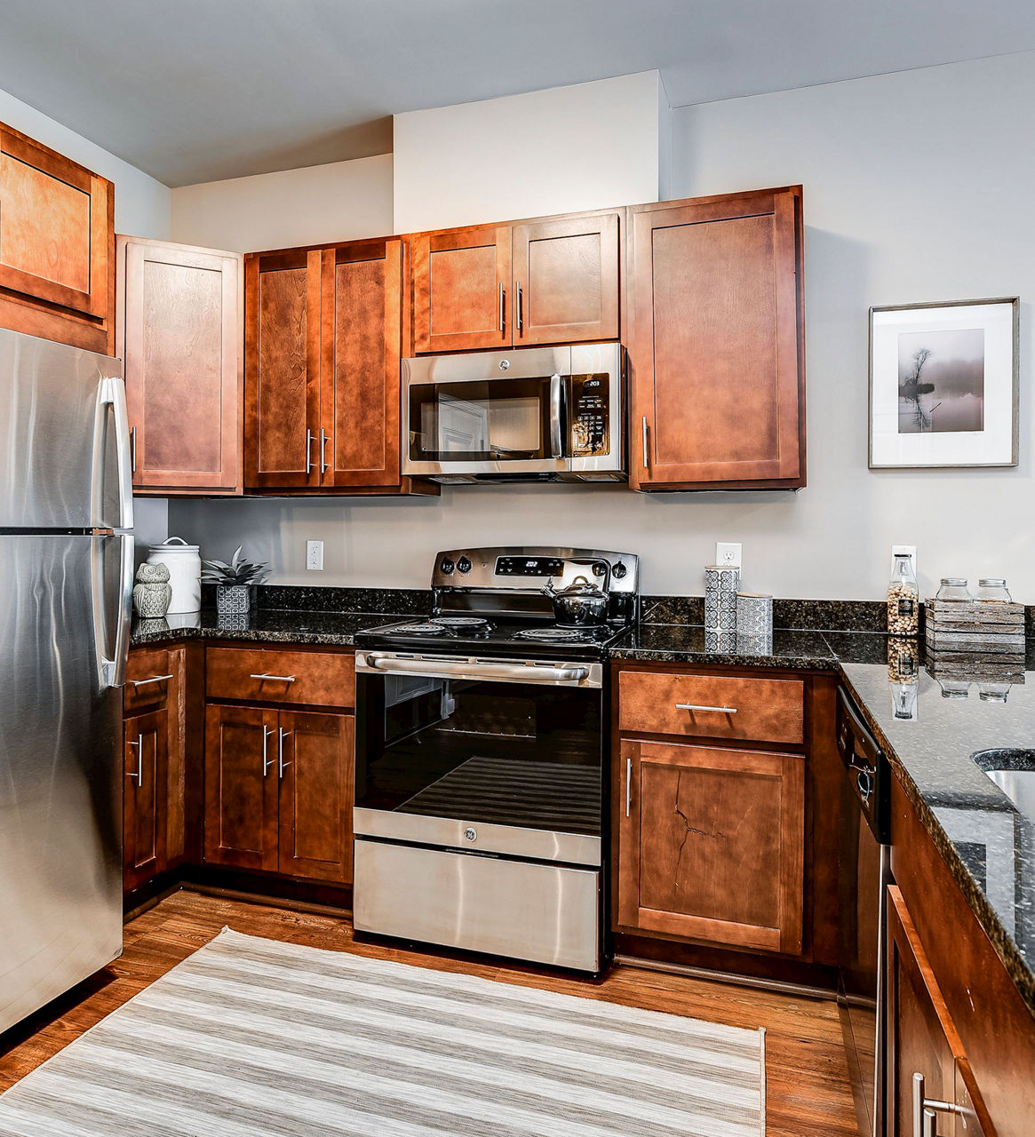 Modern kitchen with stainless steel appliances and island at Paragon at Columbia Overlook Apartments