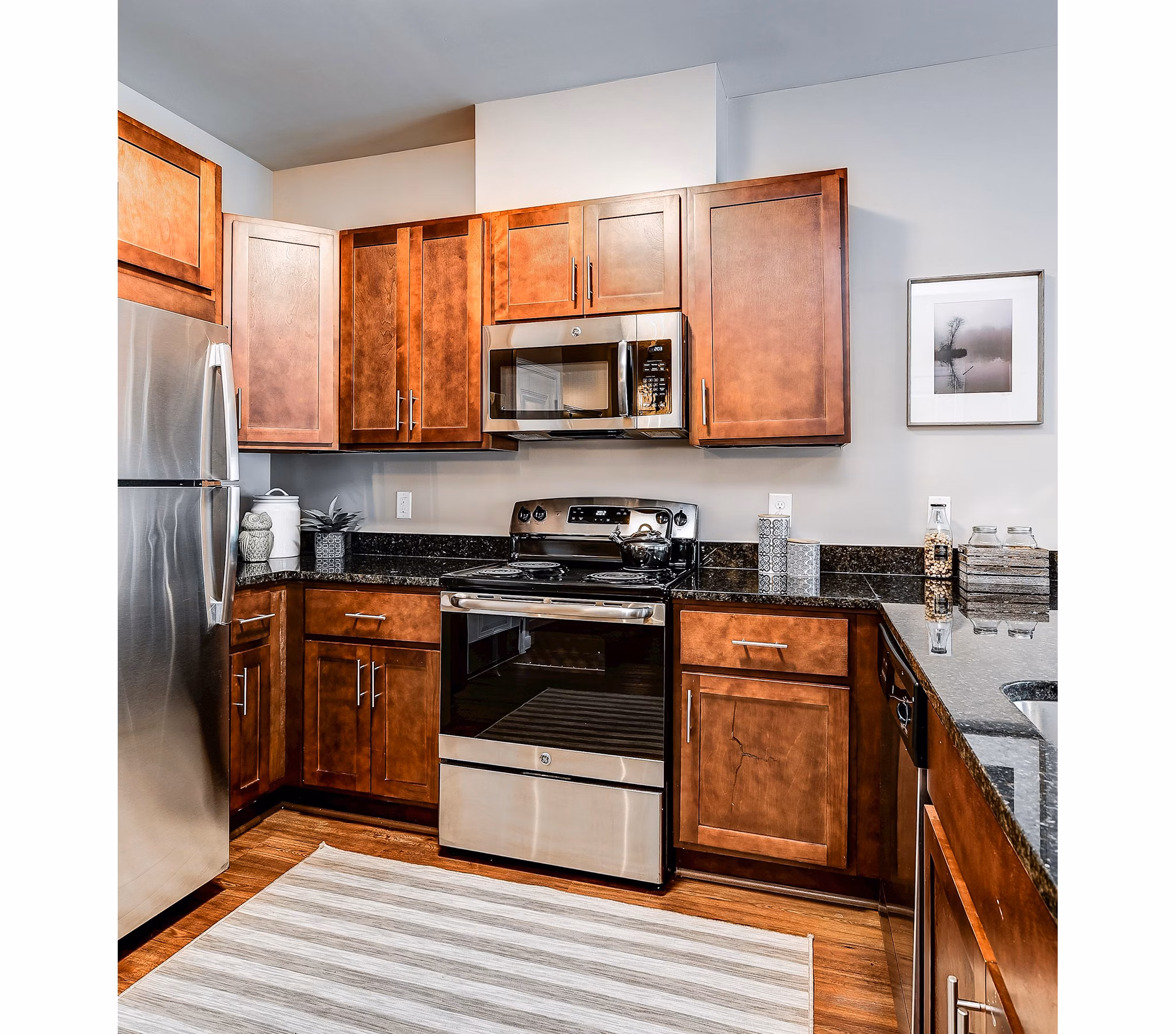 Modern kitchen with stainless steel appliances and island at Paragon at Columbia Overlook Apartments