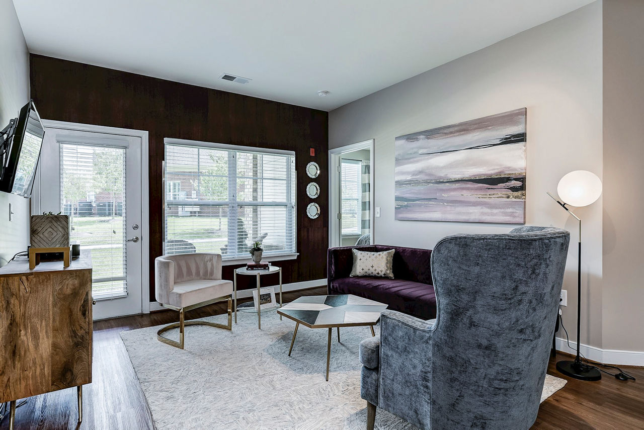 Living room featuring modern decor and natural lighting in Paragon at Columbia Overlook Apartments