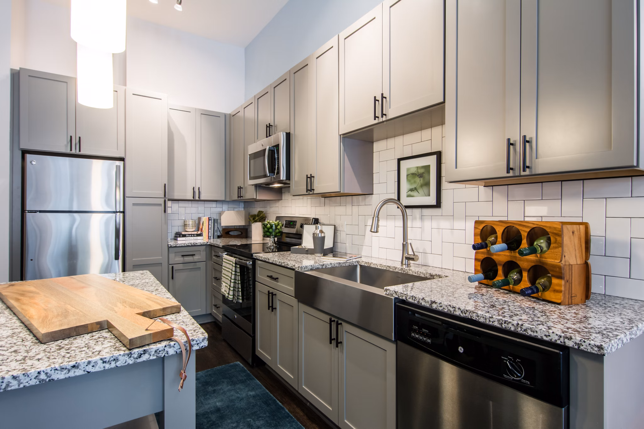 Modern kitchen featuring stainless steel appliances and granite countertops at Ellison on Broad Apartments