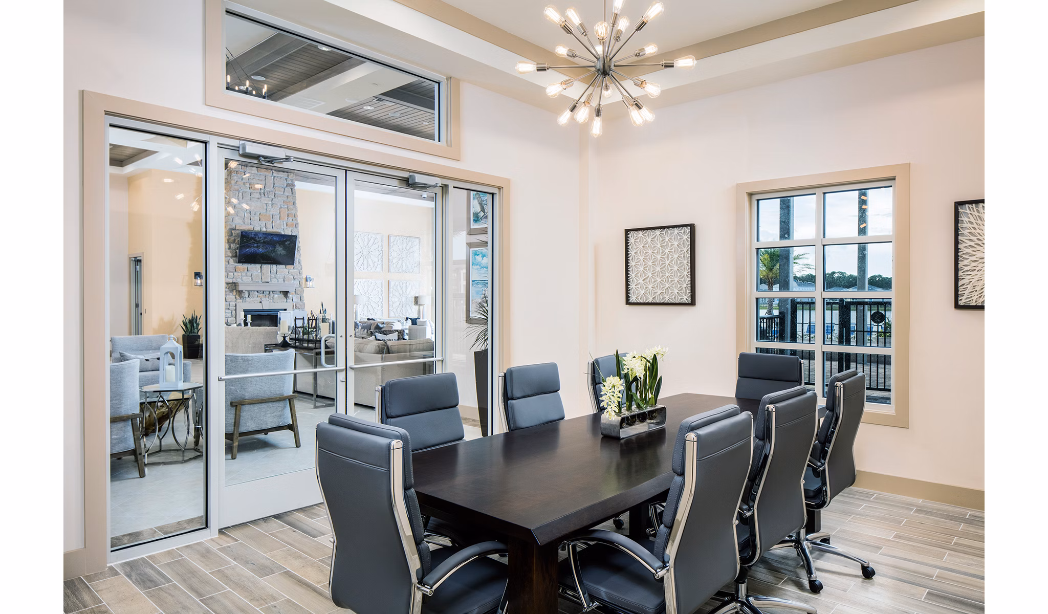Game room with pool table, foosball table, and seating area in luxury apartments