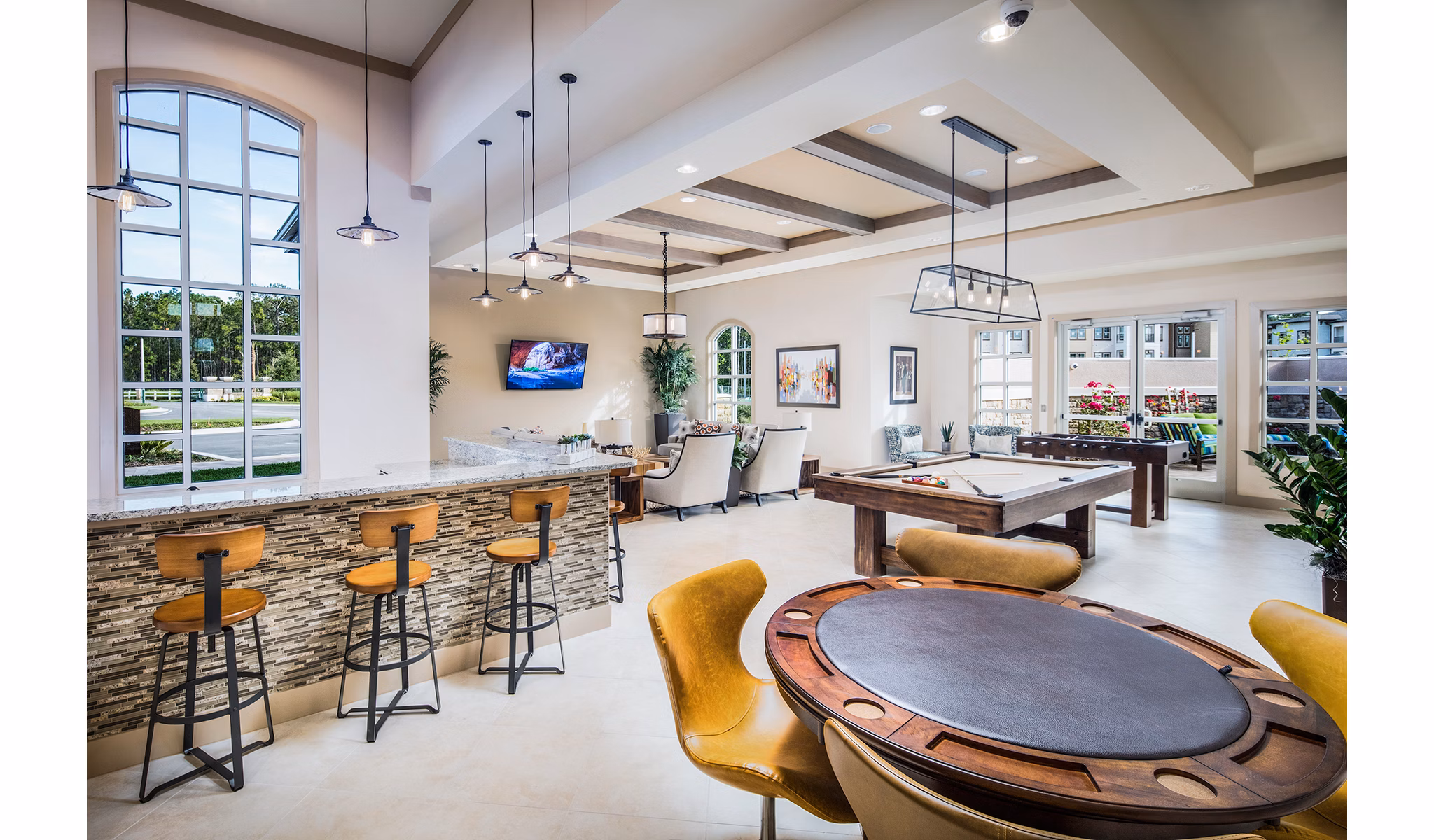 Game room with pool table and seating at Sanctuary at West Port Apartments