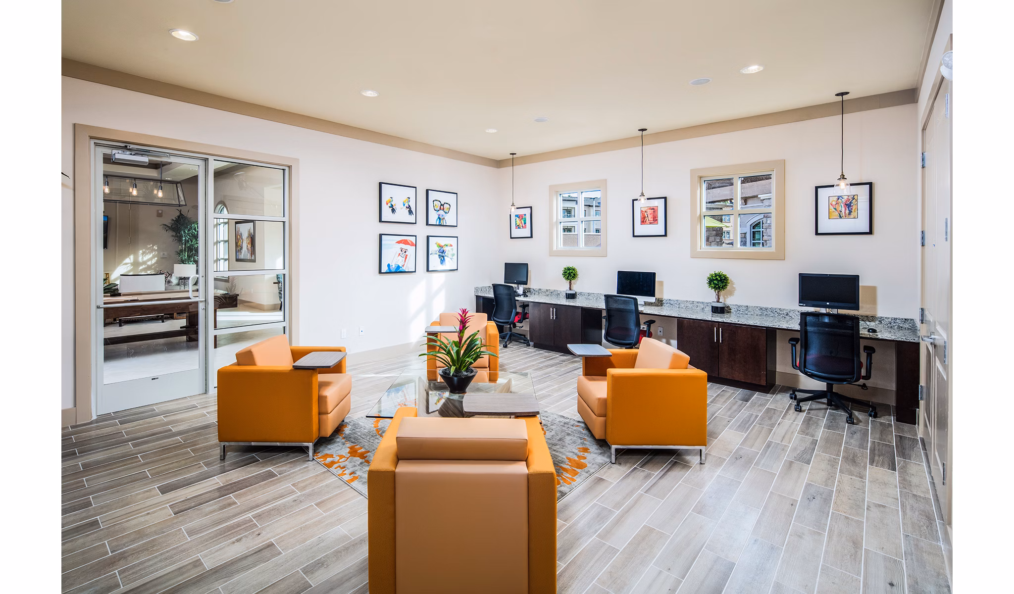 Modern business center with workstations at Sanctuary at West Port Apartments, ideal for remote work and meetings